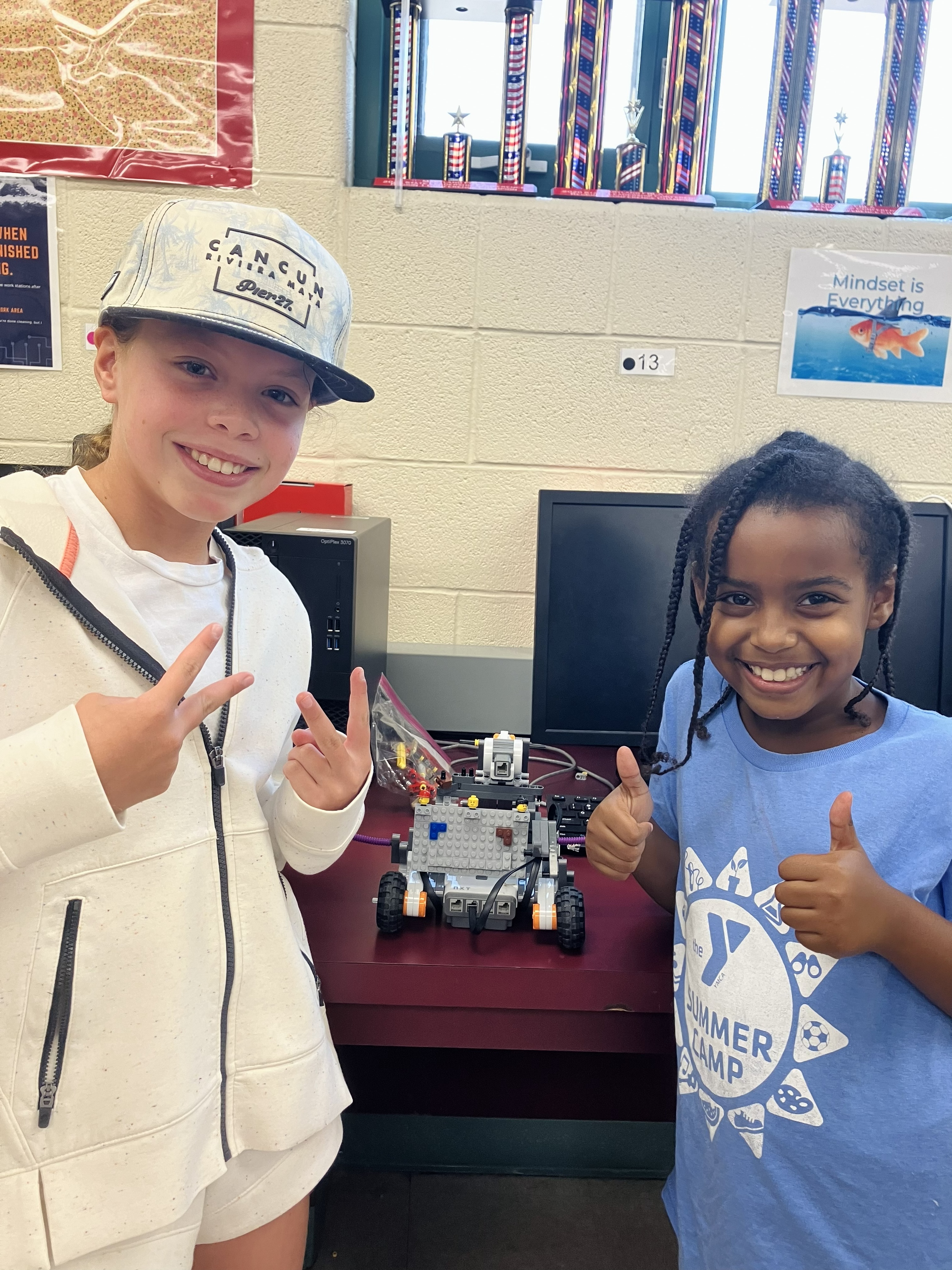 Elementary students showing off their LEGO Mindstorm robot